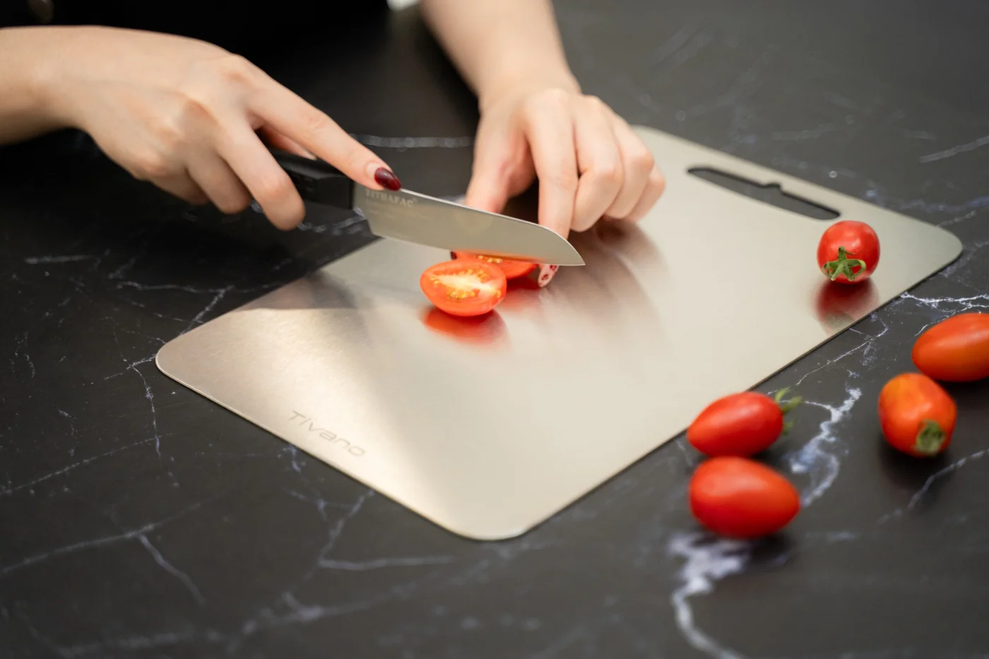 Tivano Cutting Board used to slice tomatoes in supplied product photography